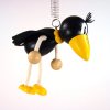 raven wooden jumping figure on spring